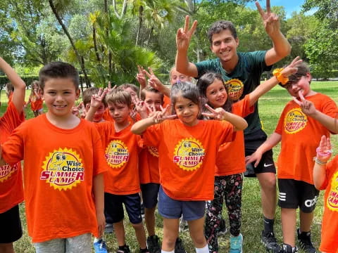 a group of boys in orange shirts