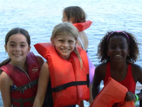 a group of girls wearing life jackets