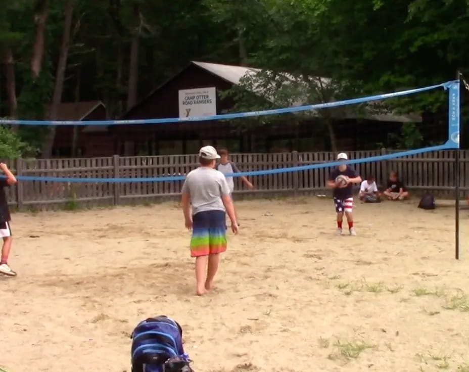 a group of people playing volleyball