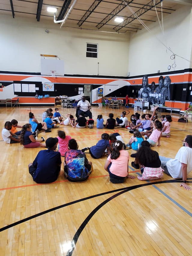 a group of people sitting on the floor in a room