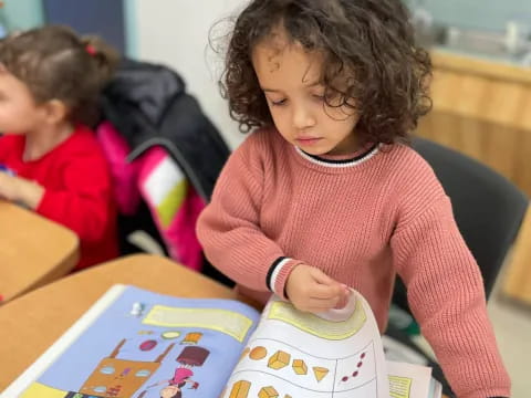 a young girl reading a book