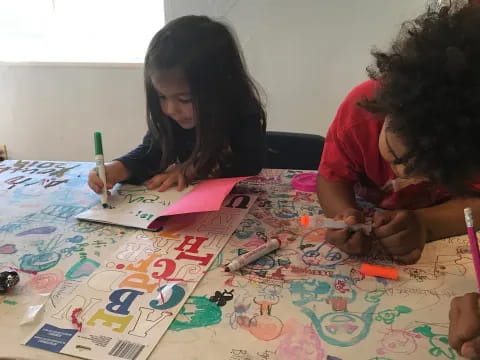 a few children sitting at a table