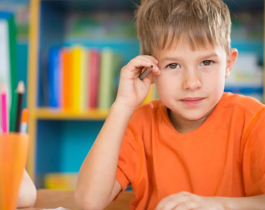 a boy sitting at a desk