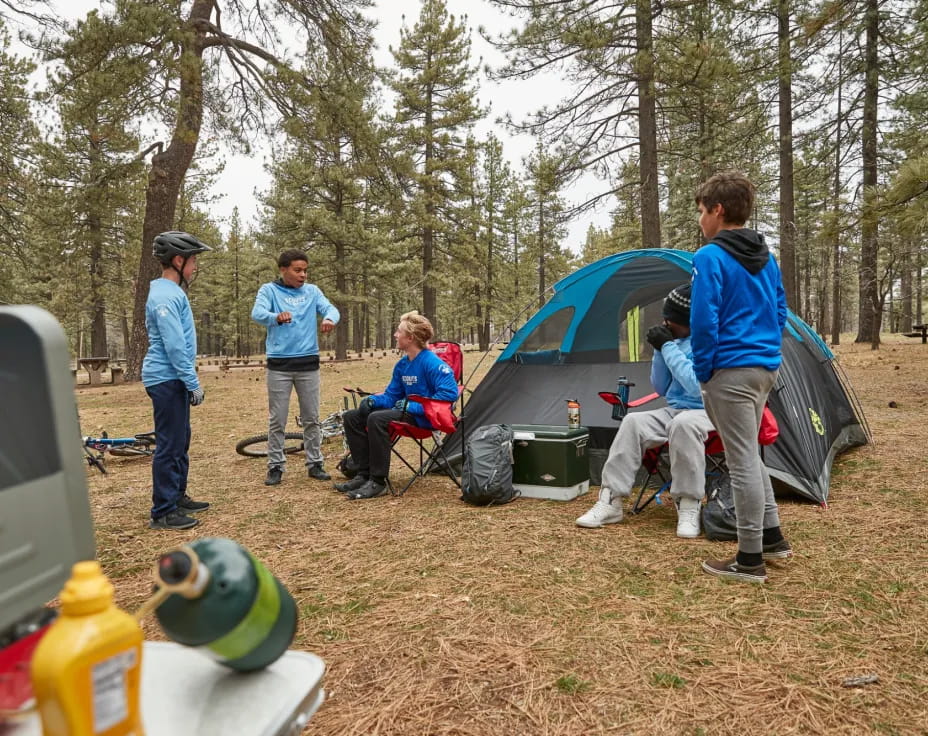 a group of people outside by a tent