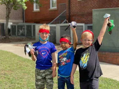 a group of kids holding bottles