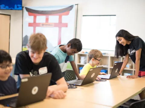 a group of people using laptops