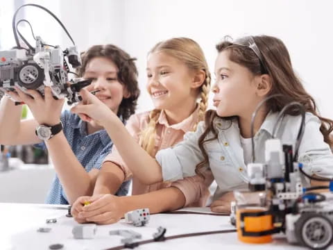 a woman and two girls looking through a microscope