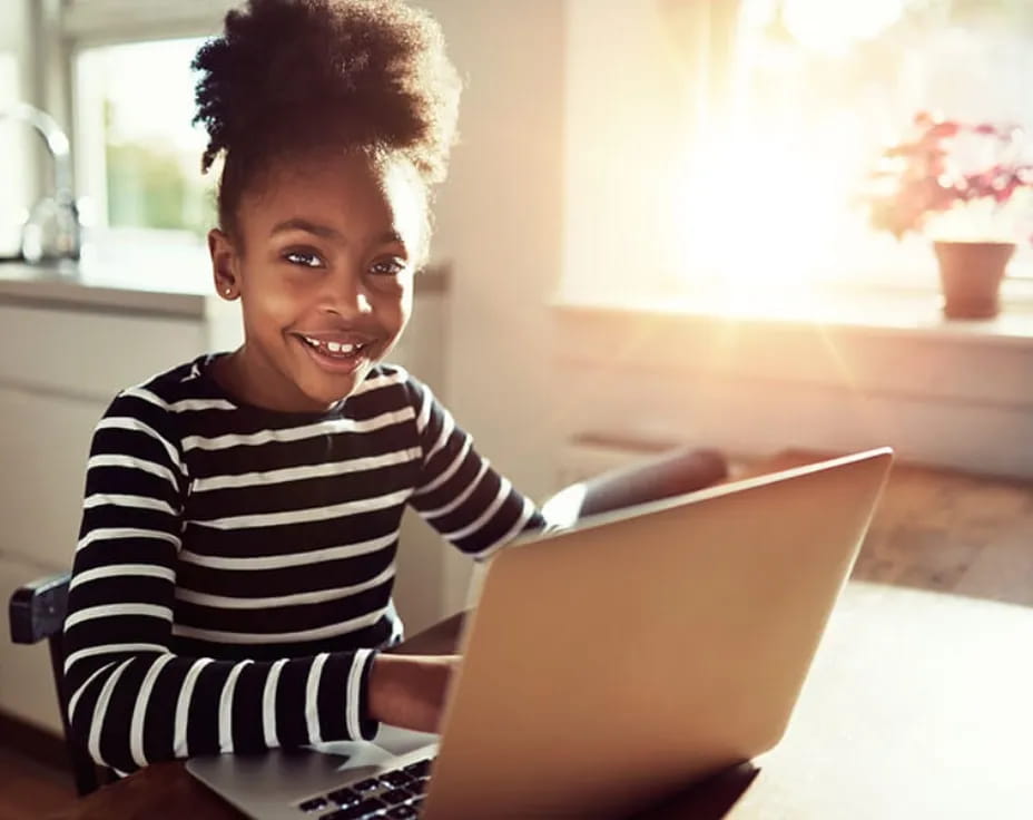 a young boy using a laptop