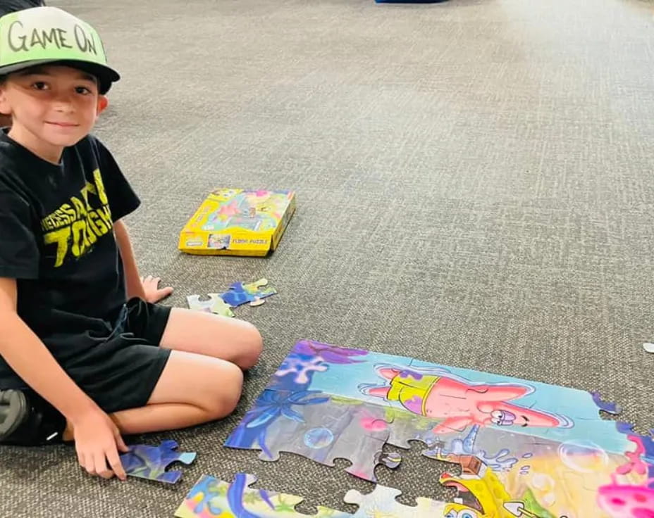 a boy sitting on the floor