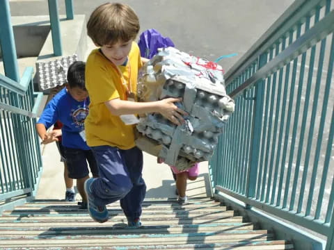 a couple of kids carrying a baby