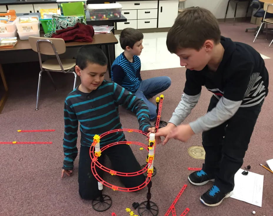 a group of boys playing with a toy