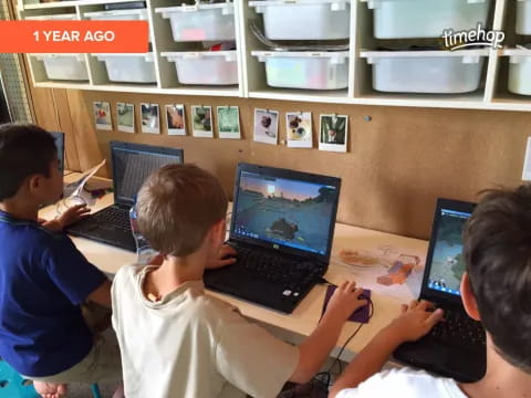 a group of people using laptops