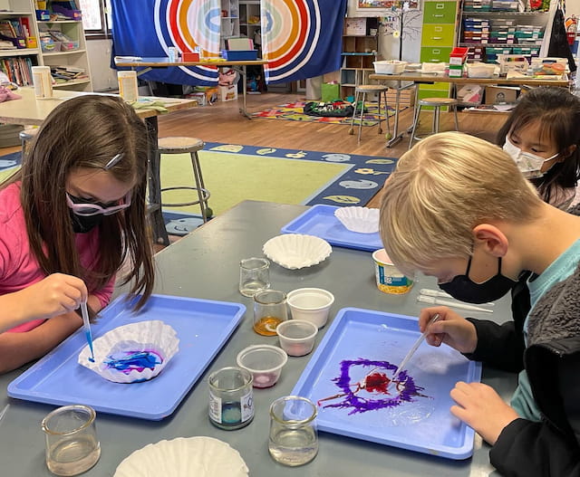 a group of children painting