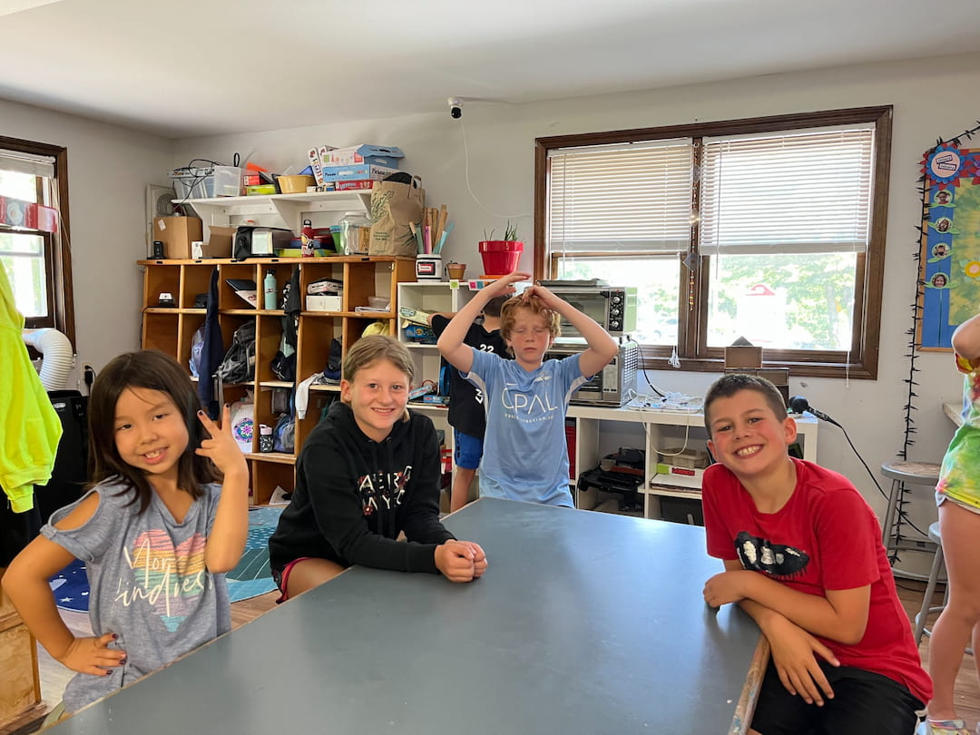 a group of kids sitting at a table