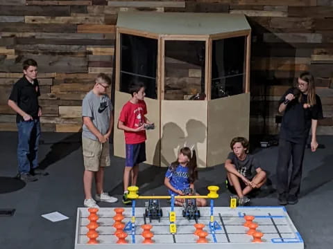 a group of people standing outside a building with a toy