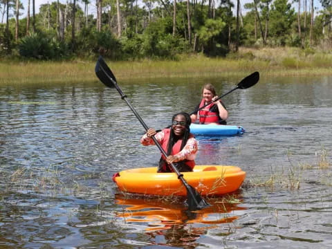 two people in kayaks on a river