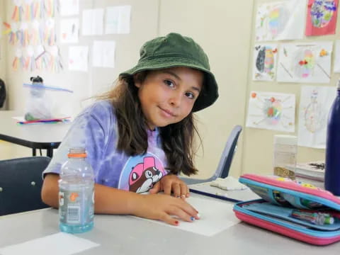 a girl sitting at a desk