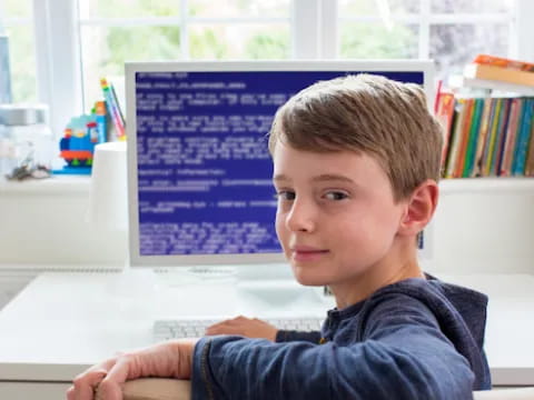 a boy sitting at a desk