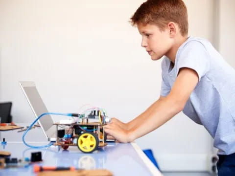 a young boy working on a toy car