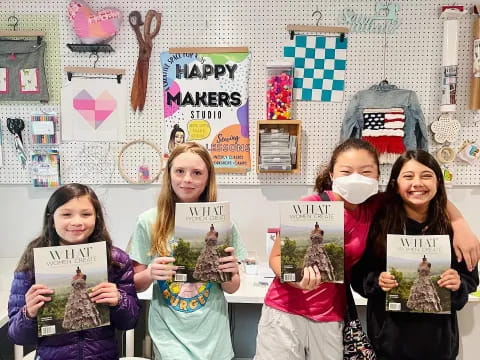 a group of girls holding up signs