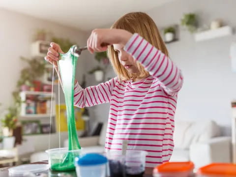 a person holding a green tube