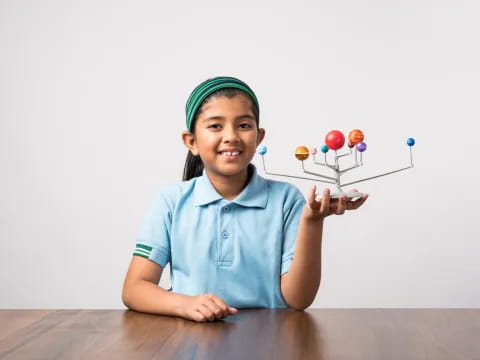 a young girl holding a balloon
