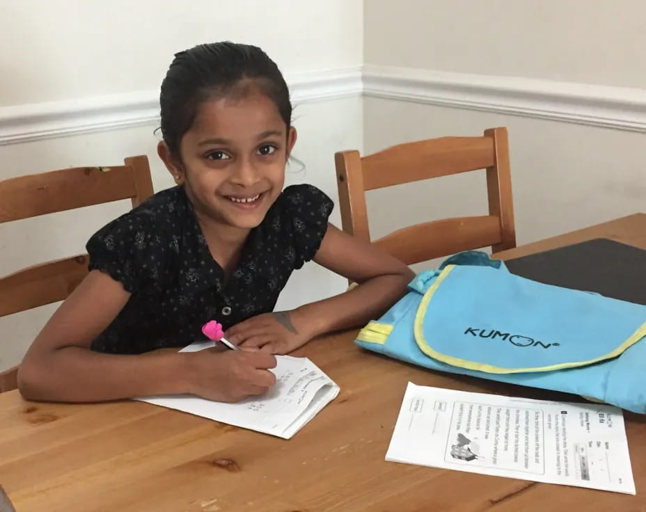a girl sitting at a table