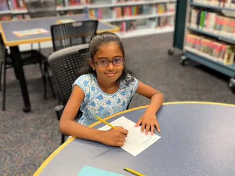 a girl sitting at a table