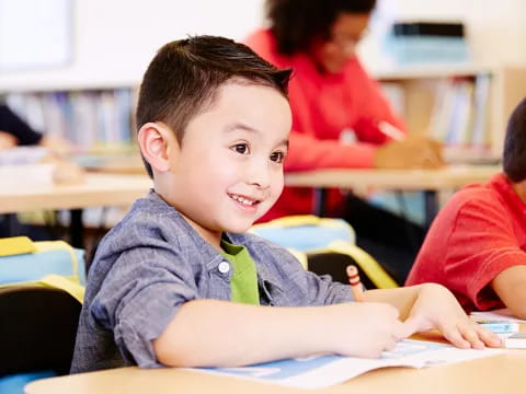 a boy sitting at a desk