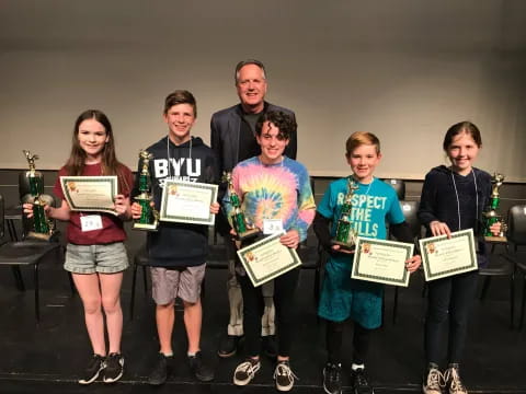 a group of people holding certificates