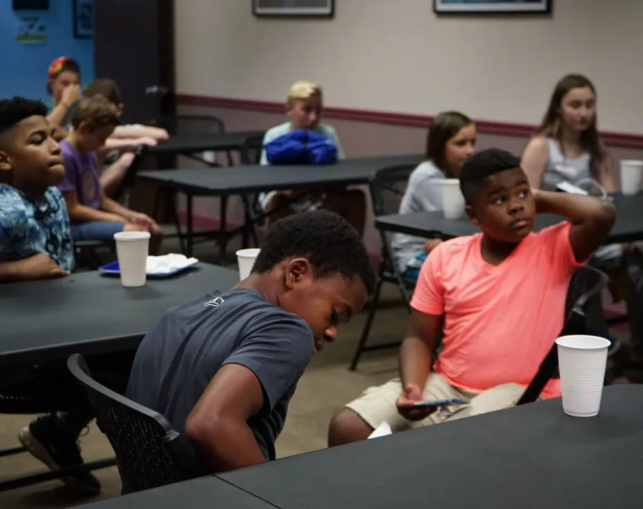 a group of people sitting at tables