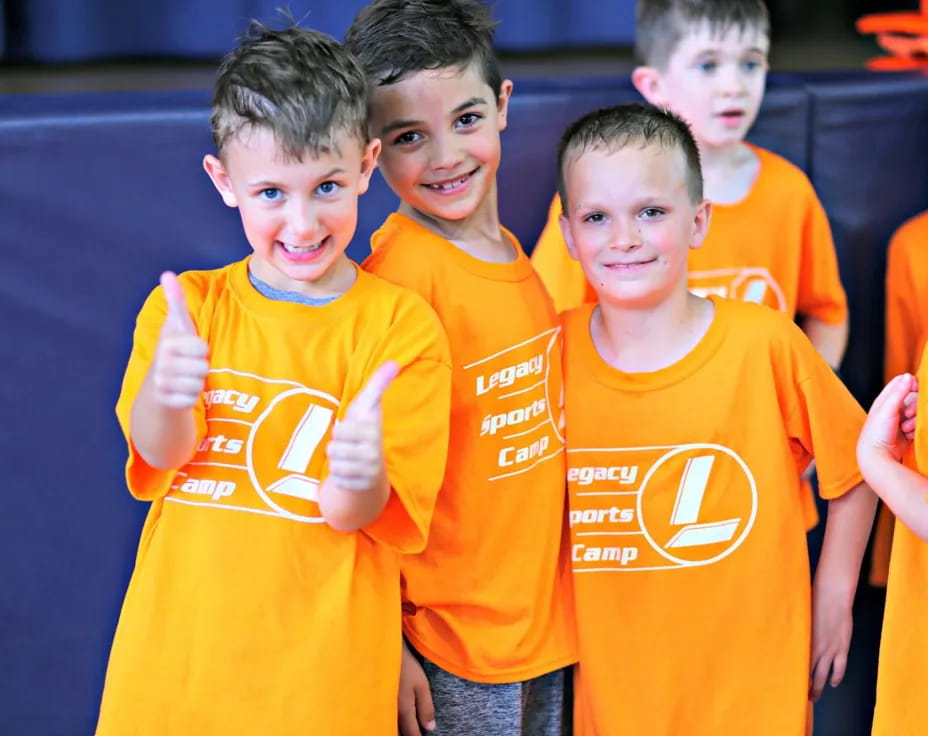 a group of boys in orange shirts