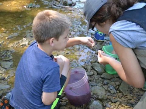 a person and a boy collecting water