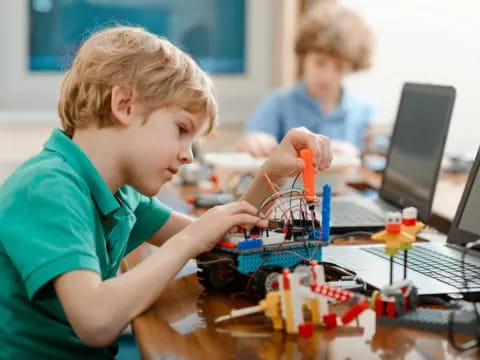 a young boy working on a computer