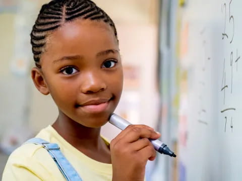 a young woman holding a pen