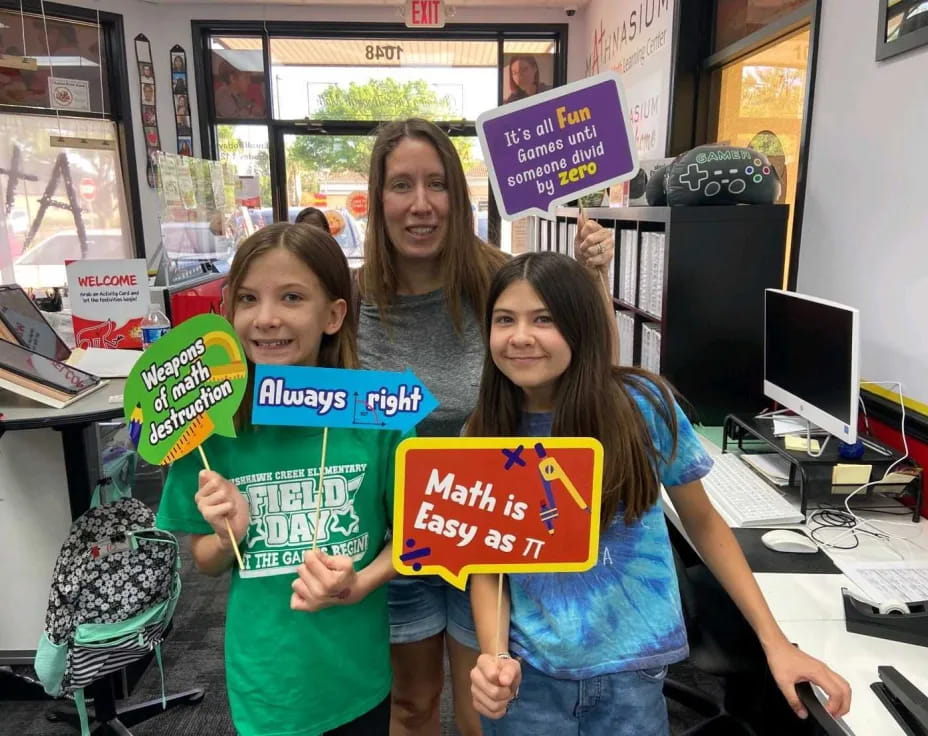 a group of girls holding signs