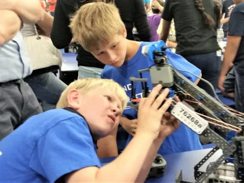 a boy looking at a microscope