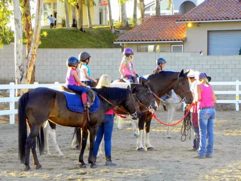 a group of people riding horses