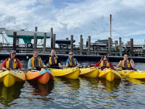 a group of people in canoes