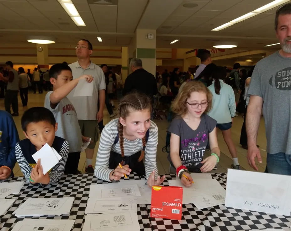 a group of people looking at papers