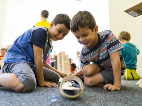 a few boys playing with a toy