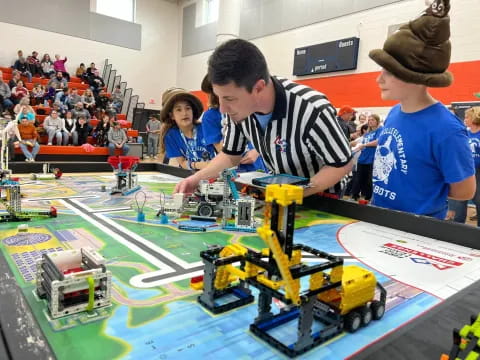 a group of people playing with a toy train