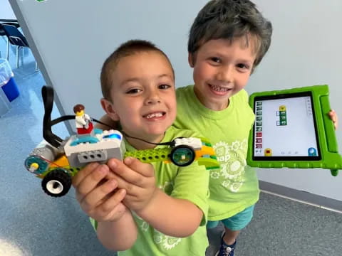 a couple of boys holding a toy