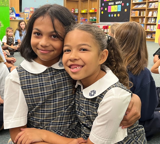 a couple of girls hugging