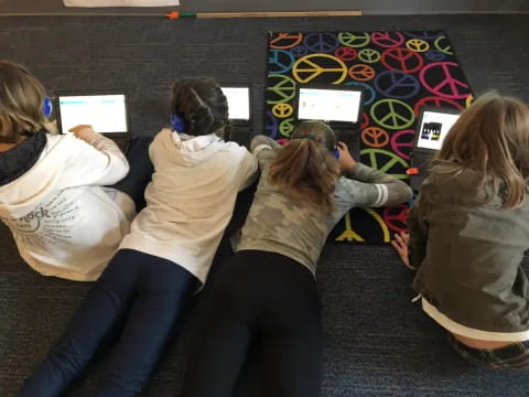 a group of people sitting in front of computers