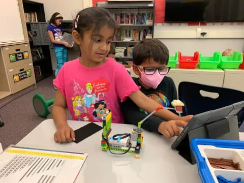 a couple of kids wearing glasses