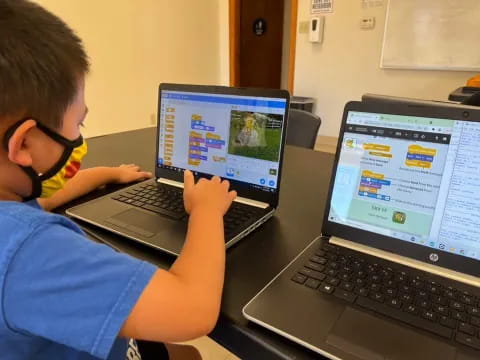 a boy using a laptop