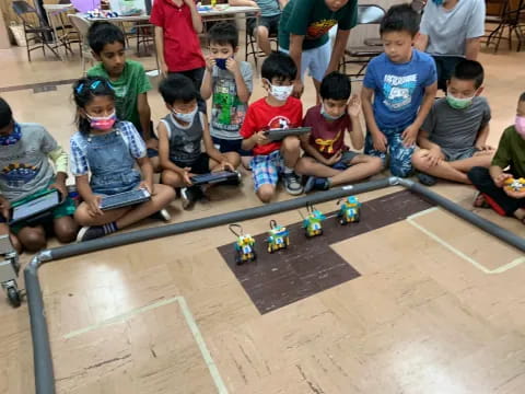 a group of children sitting on the floor playing with toys