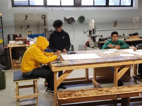 a group of men working on a table