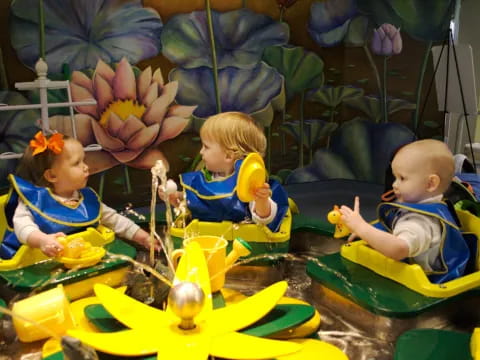 a group of babies in a toy car